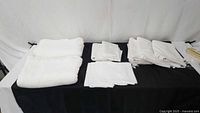 overview of all folded white linens on table