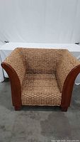 Front view of woven rattan lounge chair showing overall design