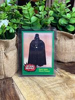 Front of 1977 Topps Star Wars Darth Vader card in protective sleeve