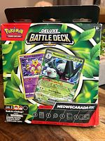 Front of sealed Python Deluxe Battle Deck Meowscarada ex packaging