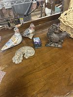 Overview showing birds, box, beagle head, rooster holder, part of basket