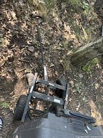 Overhead view of metal frame and handle of garden wagon showing wheel arrangement