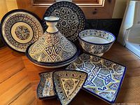 Front view of entire Moroccan dish set showing all seven pieces with colourful patterns