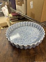 Fluted blue speckled pie dish with scalloped rim