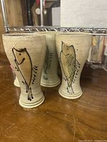 Four stoneware goblets front view showing bird designs