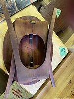 Underside view of folding wooden side table showing legs and hardware