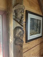 Both white pine head carvings mounted on wall