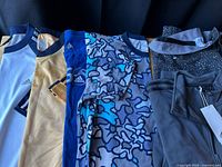 Row of assorted Adidas shirts, pants and jacket