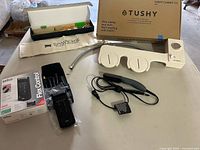 Overview of shaver, bidet, toothbrush set and straightener on table