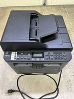Top view of Brother MFC-L2710DW printer with power cord visible