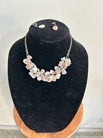 Full view of necklace on bust with earrings displayed