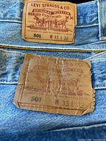 Two Levi’s 501 patches showing W33 L32 pairs