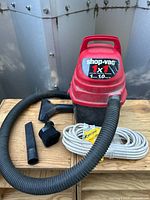 Full view of Shop-Vac unit with hose, three attachments and extension cord