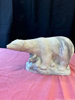 Left side view of polar bear statue showing mother and cub carving details