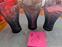 Front view of three Coca-Cola glasses
