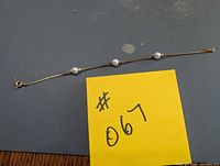 Full view of 7 in gold bracelet with three pearls and clasp