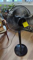 Full view of Honeywell pedestal fan showing grille, stand, base, and cord