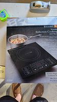 Front of box showing cooktop image and branding