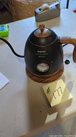 Full view of Asigo electric kettle showing handle, body and temperature gauge