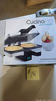Retail box showing CucinaPro Krumkake Baker model and imagery
