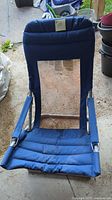 Full view of blue folding lawn chair showing frame and fabric