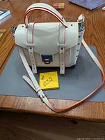 Front view of Michael Kors white satchel showing size and overall design