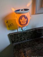 Front view of illuminated Scentsy wax warmer with Toronto Maple Leafs logo