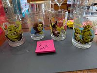 Front view of four Shrek The Third glasses showing character faces