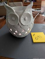 Front view of white ceramic owl wax burner showing cut-out vents and overall design.