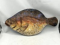 Full view of carved wooden flounder sculpture front