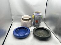 Group of four ceramic pieces showing overall lot