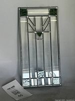 Front view of full stained glass panel showing design and hanging rings