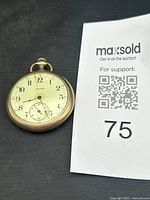 Front view showing dial design, numerals, subsidiary seconds, crown, case bezel