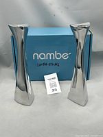 Pair of candlesticks with blue Nambe box and inserts visible