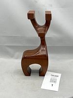 Front view of teak deer figurine