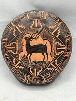 Front view of vase showing deer motif and geometric design