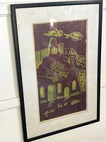 Full view of framed woodcut print under glass