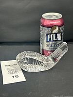 Full view of crystal golf club head paperweight beside soda can for scale and lot tag