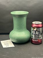 Full view of Zanesville Pottery matte green vase with soda can for size reference
