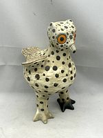 Front view of spotted ceramic owl showing color and form