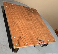View of the wooden platform and caster wheels showing overall structure and condition.