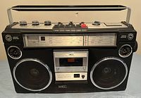Front view of Sears boom box showing radio dial, cassette compartment, speakers, and control buttons.