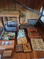 Overall view showing table and assortment of decorative wooden boxes arranged on floor