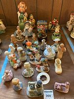Overall view of assorted figurines and music boxes on table