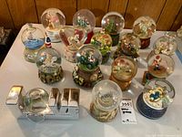 Full assortment of snow globes on table
