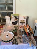 Overall lot showing boxed items, bowls, flatware, knives