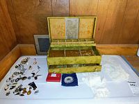 Overview of jewelry box open with assorted jewelry, gloves, lace accessory and boxes