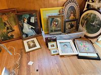 Overall lot view showing framed prints, paintings and decorative plates