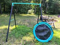 Full view of A-frame swing set, saucer swing resting against frame