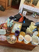 Overview of assorted planters, stained glass pieces, decorative plaque, wind spinner package